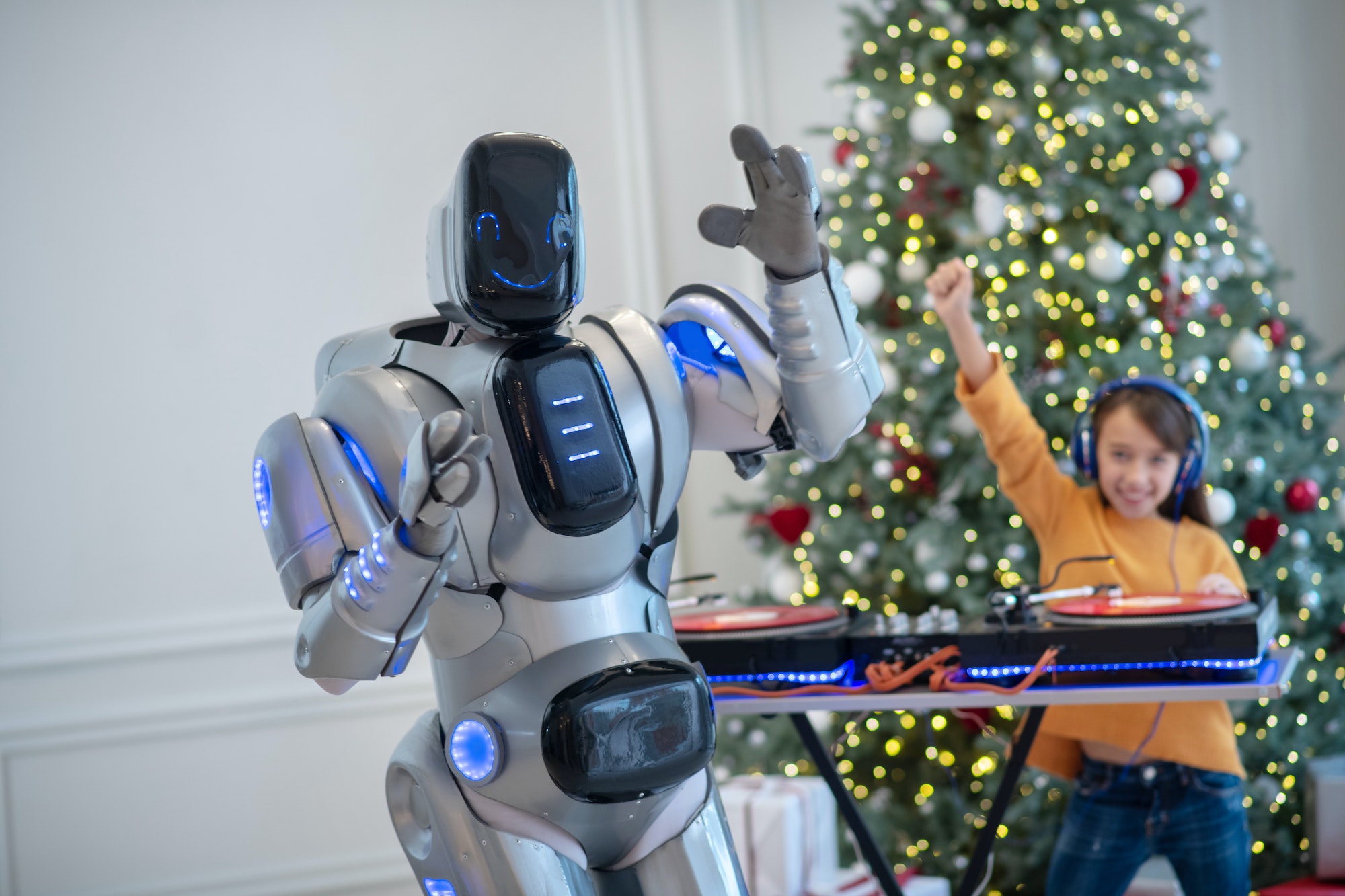 Girl and robot choosing music for the new year party